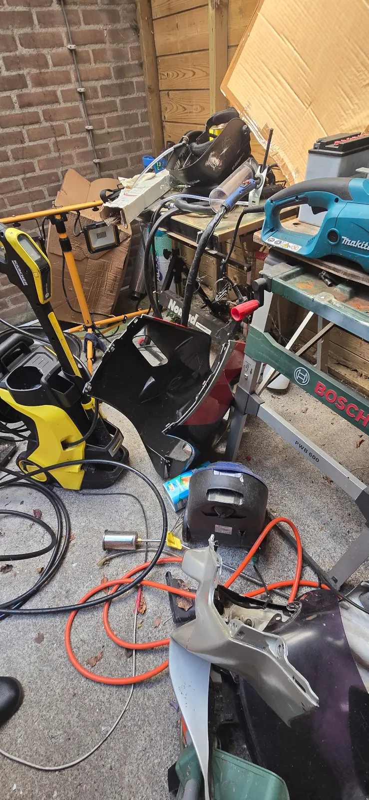 Motorcycle parts and workshop tools awaiting selection